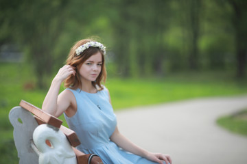 Girl in blue dress in green park