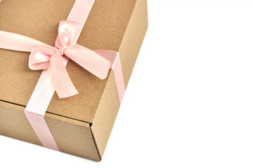 Kraft gift box with pink bow on white background and copy space