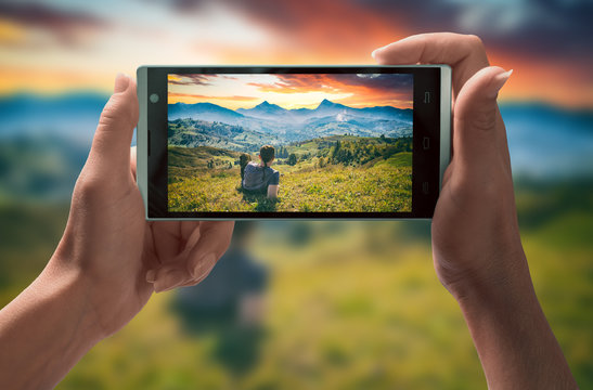 Man in a mountain valley on smartphone screen