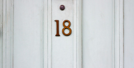 Number 18 on a white house door 