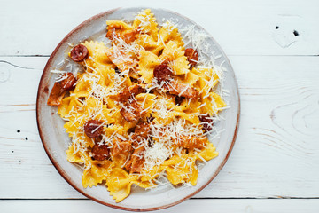 Delicious homemade Italian pasta carbonara with sausages, pancetta and parmesan cheese top view space for text 