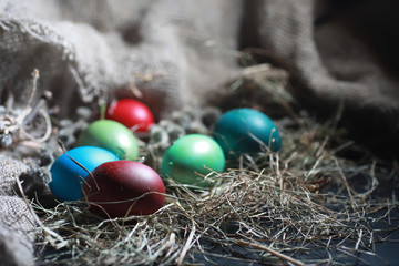 Fototapeta na wymiar Easter painted eggs on burlap