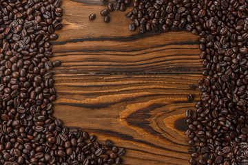 Coffee beans on vintage wood background. Copy space