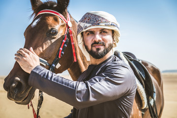 Arabian man with horse in the desert