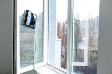 Vacuum cleaner robot cleaning window in high building outdoor