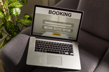 omputer laptop with hotel booking screen in room