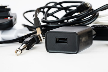 Different wires and connectors on a white background, equipment mess closeup shot
