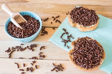 rusk with chocolate sprinkles, Dutch Hagelslag, on blue napkin and wooden table