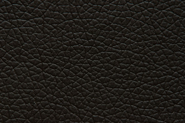 Dark brown artificial leather with large texture, background.