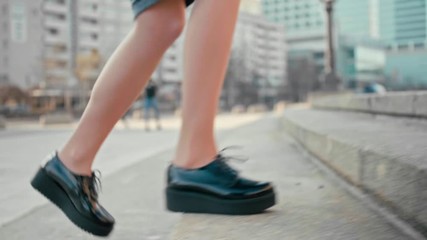 Close Up 4K Slow Motion Shot of Woman Walking Upstairs Outdoors in City. Female Feet in Patent Platform Shoes Making Steps to Climb Up the Stairs