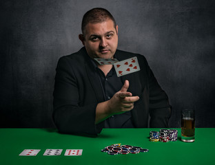 White Man throwing cards while gambling, playing poker 