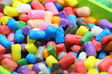 Heap of colorful sweet crunchy corn sticks / snack food