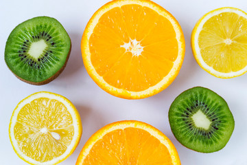 Fototapeta na wymiar Colorful fresh fruits on white background. Orange, mandarin, kiwi, lemon. Fruit background. Summer food concept.