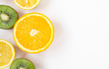 Colorful fresh fruits on white background. Orange, mandarin, kiwi, lemon. Fruit background. Summer food concept.