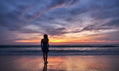 Fototapeta na wymiar girl at sunset by the sea