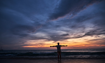 Man watching sunset on the beach