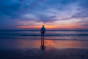 Fototapeta premium Man watching sunset on the beach