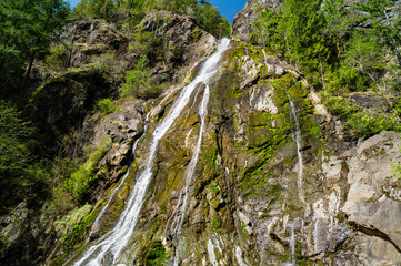 Fototapeta na wymiar Rocky Brook Falls flows out of the Olympic National Park near Brinnon, Washington on Washington's Olympic Peninsula