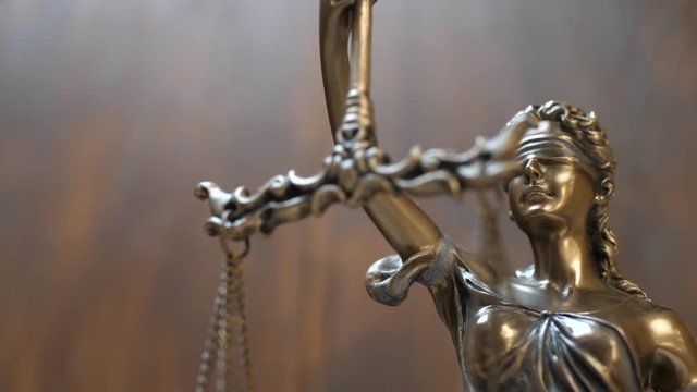 The Statue of Justice on Wooden Background. Concept of legal law, advice and justice