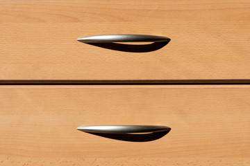Two plain wooden drawers with metal handles and shadow for office, home, bedroom, study