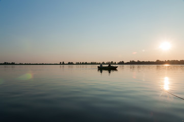Fishermen in a boat at sunrise