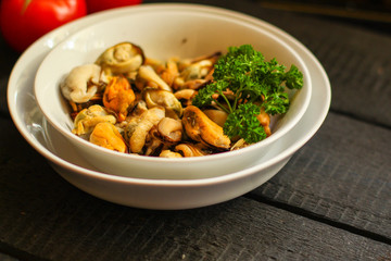 mussels A serving of seafood is a white plate. food background. top image