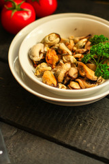 mussels A serving of seafood is a white plate. food background. top image