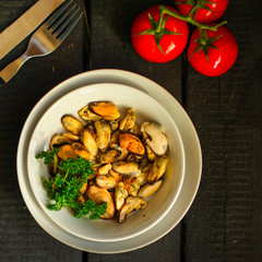 mussels A serving of seafood is a white plate. food background. top image