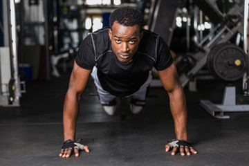 Black African American  young man doing  workout at the gym - Powered by Adobe