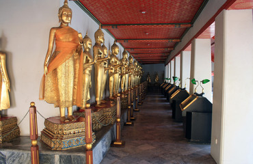 Fototapeta premium 07 February 2019, Bangkok, Thailand, Wat Pho temple complex. Alley with Golden Buddhas