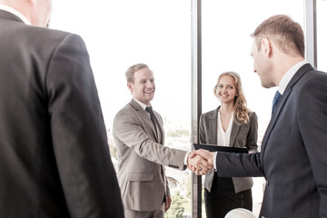 Happy business people shaking hands