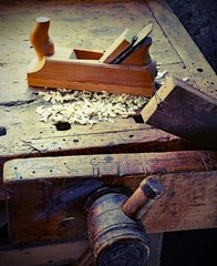 Planer shavings and sawdust on the wooden Workbench with old ton