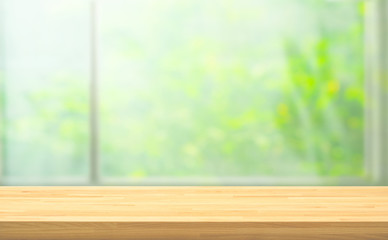 Wood table top on blur of window with garden flower background in morning