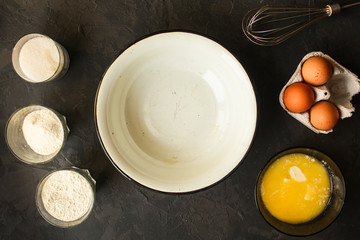 bowl, ingredients and kitchen gadgets for making dough. food background. top image