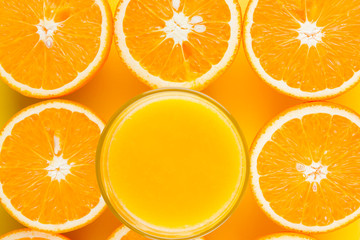 Cut halves of juicy orange on yellow background. Orange fruit, citrus minimal concept. Creative summer food minimalistic background. Top view, flat lay