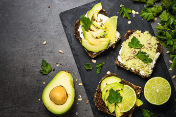 Sandwiches with avocado on black.