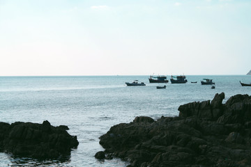 February 14, 2019, Phuket, Patong beach, Thailand. Boats on the sea and rocky shore.