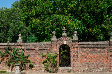 brick wall with gate in public park of Castle Eijsden, The Netherlands