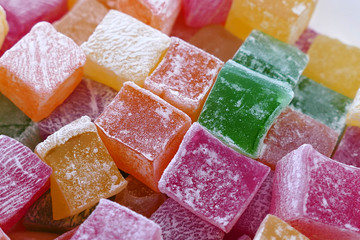 red, green, yellow and orange small Turkish delight, close up of tiny turkish delight in plate