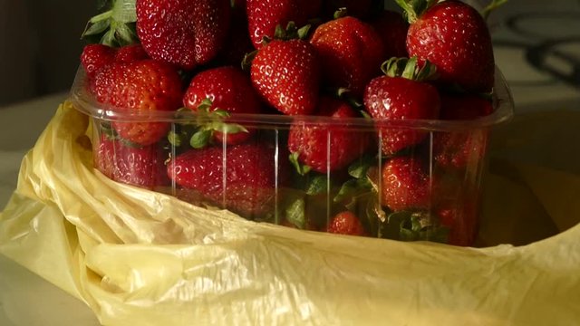 natural strawberries in a transparent container, close-up, 1 kg natural strawberry in package, close-up,