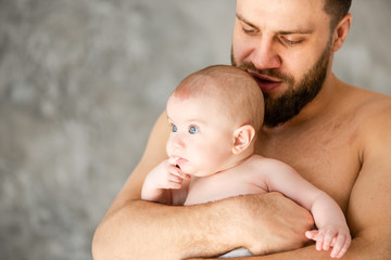 Father kissing head of his little daughter.