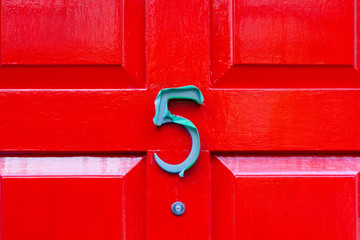 House number five with the 5 covered in green plastic