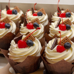 cupcakes with cream and fresh berries and biscuits