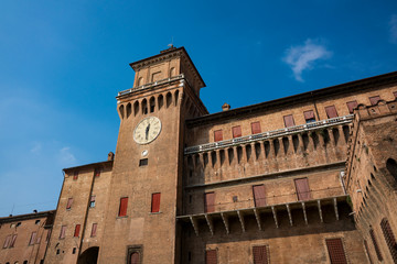 Fototapeta premium tower with clock, of Castello Estense, St Mchael's Castle, Ferrara, Italy