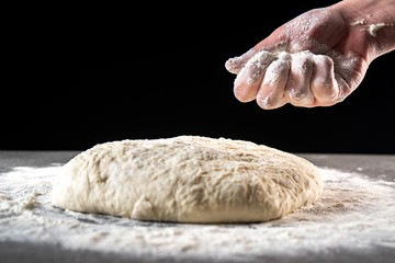 Making dough by female hands at bakery