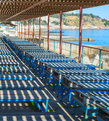 Old wooden deck-chair beach Crimea