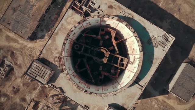Abandoned and ruined Nuclear Power Plant in Shelkino, Crimea. Large USSR industrial construction with round tower of atomic reactor, aerial view