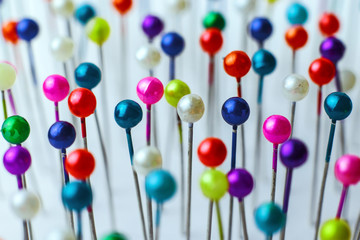 Sewing pins. Colorful sewing pins background. Close Up of sewing pins with multi colored heads. Part of set.