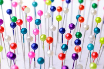 Sewing pins. Colorful sewing pins background. Close Up of sewing pins with multi colored heads. Part of set.