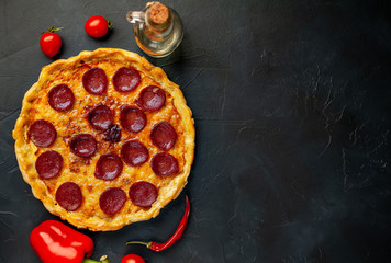 Tasty pepperoni pizza of tomatoes and ingredients on concrete background. Top view of hot pepperoni pizza.,copy space for your text